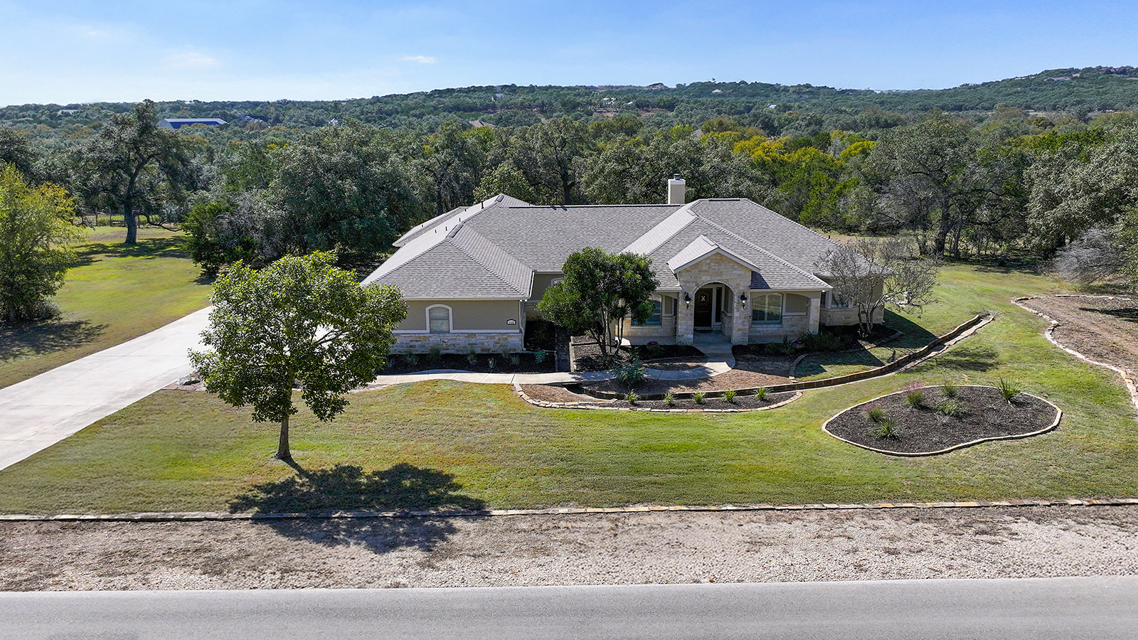 Front exterior of Hill Country home in Comal Trace – private 2.67-acre property, view full video tour on our website.